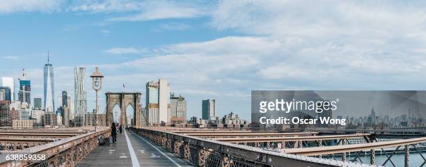 panorama of brooklyn bridge against new york cityscape - brooklyn heights stock pictures, royalty-free photos & images