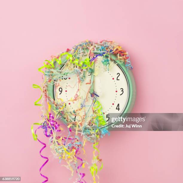 Clock covered in confetti and party streamers