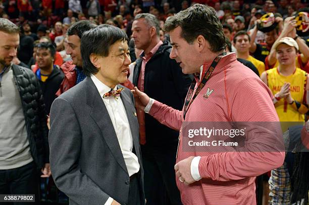 Kevin Plank, Under Armour founder and CEO, talks with University of Maryland President Wallace Loh before the game between the Maryland Terrapins and...