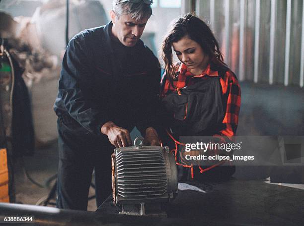 machinist examining electric motor with voltmeter - voltmeter stock pictures, royalty-free photos & images