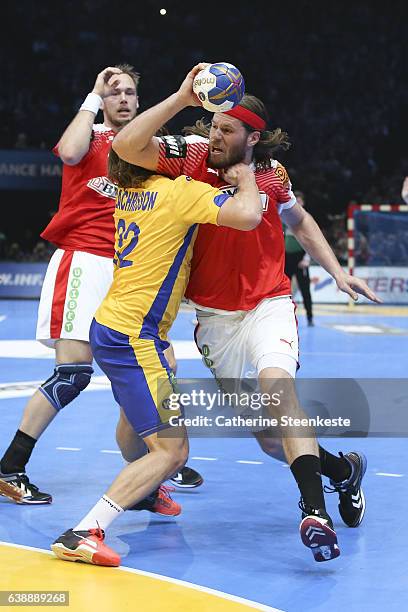 Mikkel Hansen of Denmark is trying to shoot the ball against Mathias Zachrisson of Sweden during the 25th IHF Men's World Championship 2017 match...