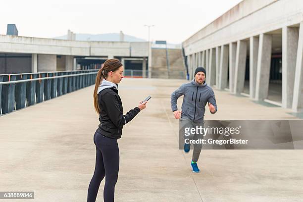 personal trainer with stopwatch - running coach stock pictures, royalty-free photos & images