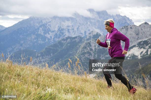 woman running on mountain - senior women hiking stock pictures, royalty-free photos & images
