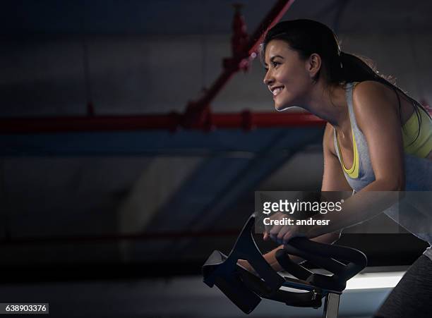woman exercising at the gym - cycling gym stock pictures, royalty-free photos & images