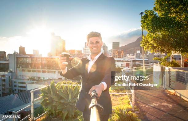 man with a selfie stick. - early bird catches the worm stock pictures, royalty-free photos & images