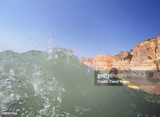 boy having  fun with waves in the sea