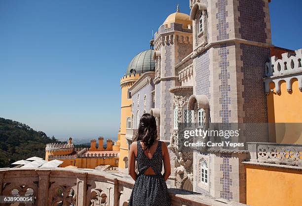 young woman standing in front of palace da pena, sintra,portugal - sintra portugal stock pictures, royalty-free photos & images