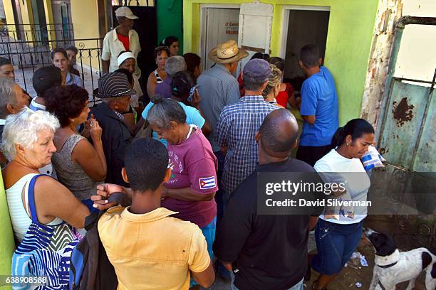 Cubans collect their ration of yogurt on December 21, 2015 in Vinales, Cuba. Cubans continue to abide by a decades-old food rationing system...