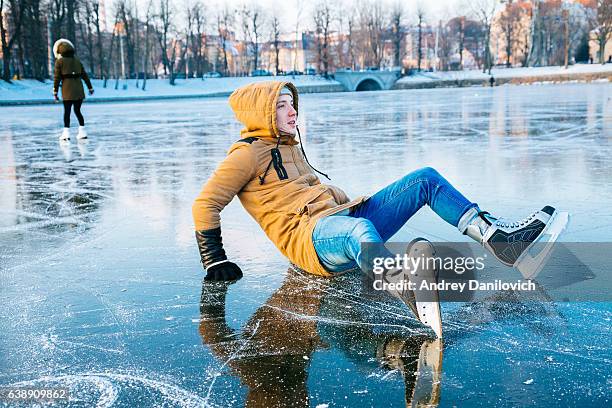 ice skating on the frozen lake - person slipping on ice stock pictures, royalty-free photos & images