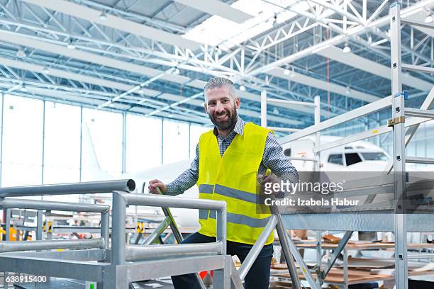 aircraft engineer in a hangar - izabela habur stock pictures, royalty-free photos & images