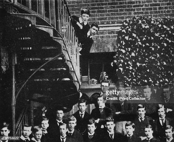 Winston climbing a staircase, while the class pose' . Winston Churchill and friend stand on a staircase during a class photograph at Harrow. From...