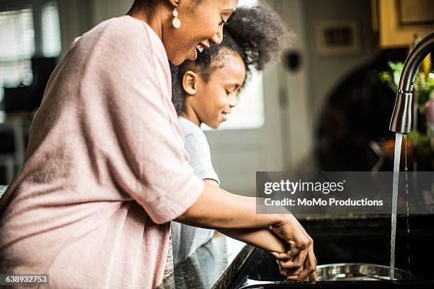 mother and daughter doing dishes - kitchen sink water stock pictures, royalty-free photos & images