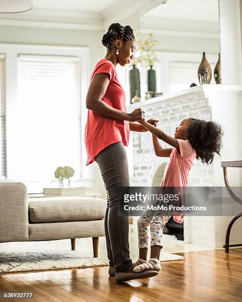 girl dancing on mothers feet