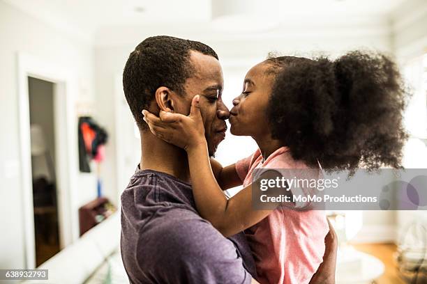 daughter kissing father on the nose - nariz humano fotografías e imágenes de stock