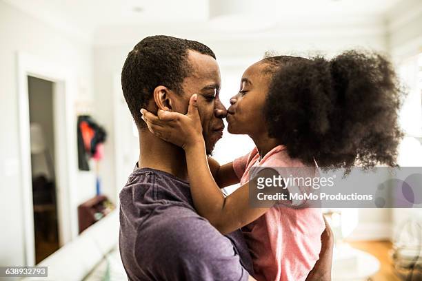 daughter kissing father on the nose - candid stock pictures, royalty-free photos & images