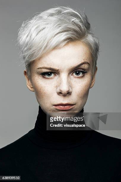 woman with raised eyebrow - young woman gray hair stock pictures, royalty-free photos & images