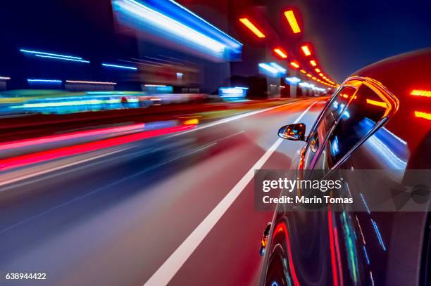 night car driving downtown - rear light car stock pictures, royalty-free photos & images