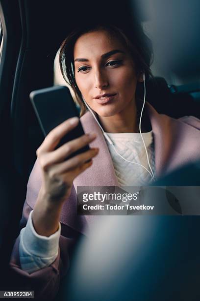 woman listening to music in a car - motorheadphones stock pictures, royalty-free photos & images
