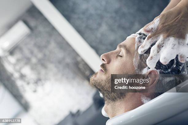 at the hairdresser - haar wassen stockfoto's en -beelden