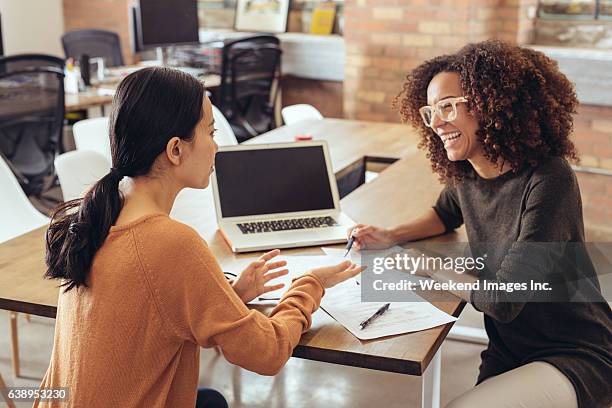 discussing the new marketing strategy - business couple stockfoto's en -beelden