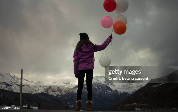 Teen girl holding colour balloons