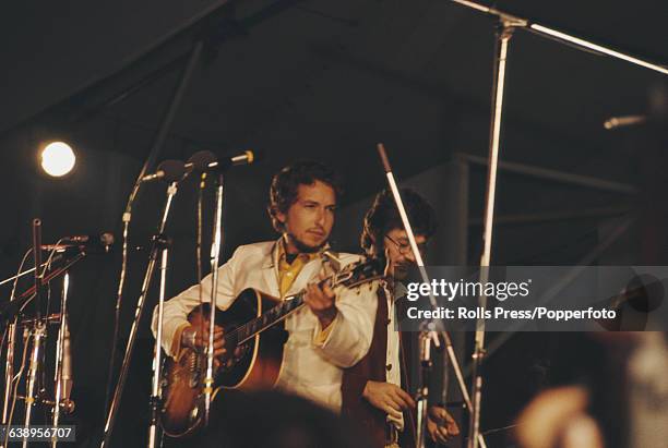 American musicians Bob Dylan and Robbie Robertson of The Band perform together on stage on the last day of the 1969 Isle of Wight Festival on the...