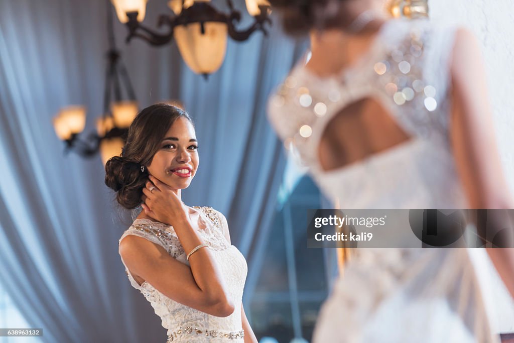 Young mixed race woman in elegant white dress