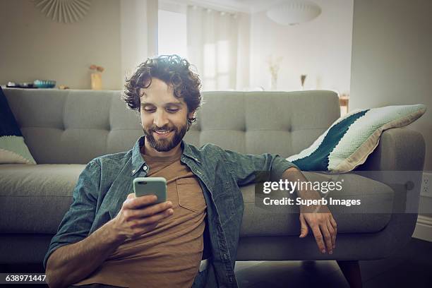 man checks smartphone - only men ストックフォトと画像