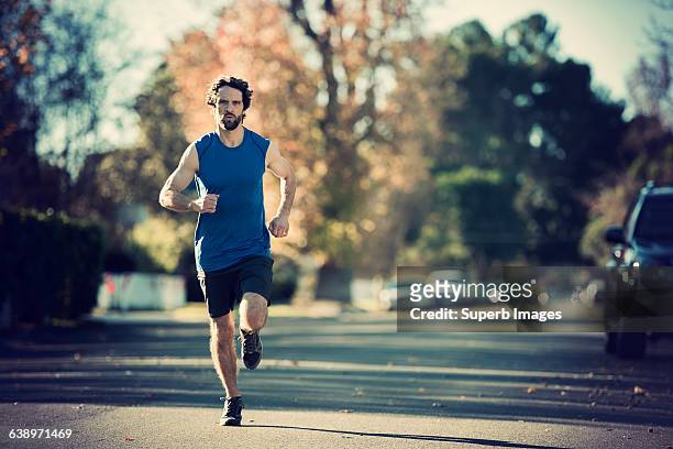 man running in neighborhood - day in the life stock pictures, royalty-free photos & images