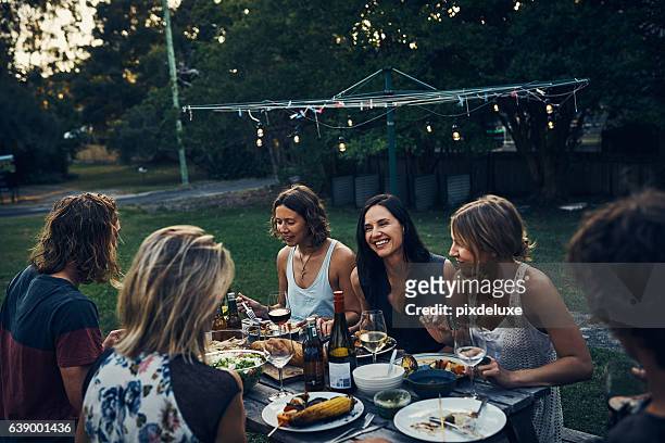 sitting down with friends and family for a nightly meal - evening meal stock pictures, royalty-free photos & images