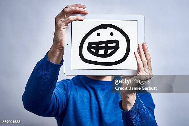 a male showing his feelings drawn on a tablet - newnaivetytrend ストックフォトと画像