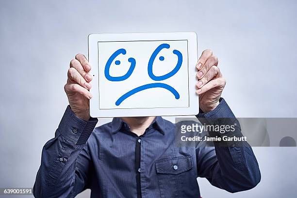 a male showing his feelings drawn on a tablet - newnaivetytrend ストックフォトと画像