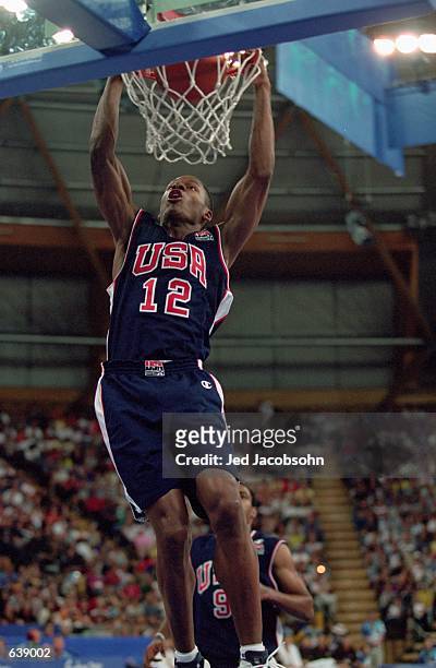 Ray Allen of the USA hangs on the rim after slam dunking the ball during the Men's Basketball game against China for the 2000 Sydney Olympics at The...