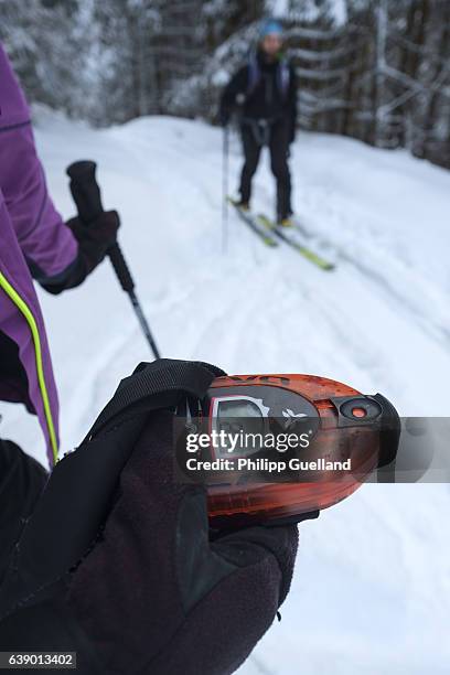 Backcountry skiers check their avalanche beacons before starting on a ski touring trek up the Scheinberg mountain in the Ammergau alps on January 15,...