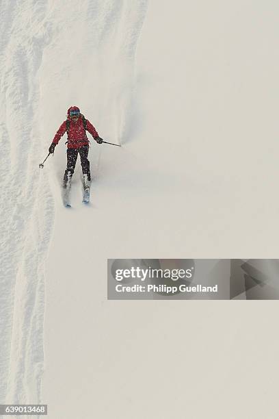 Skier descends a slope through powder on a ski touring trek up the Scheinberg mountain in the Ammergau alps on January 15, 2017 near Oberammergau,...