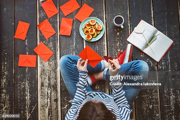 young woman writing a valentine card - top view - alexandra iakovleva stock pictures, royalty-free photos & images