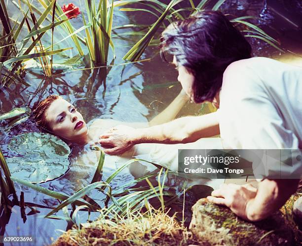 Nick Cave and Kylie Minogue making a video for their duet 'Where the Wild Roses Grow' from the album 'Murder Ballads', United Kingdom, 24th July 1995.