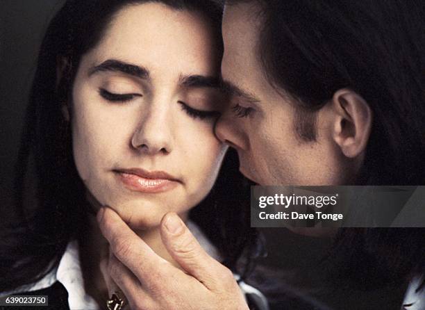 Portrait of Australian singer-songwriter Nick Cave and English singer-songwriter PJ Harvey to promote their duet 'Henry Lee' from the album 'Murder...