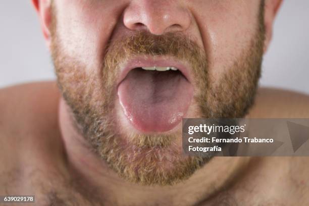 man with pain gesture - sticking out tongue stock-fotos und bilder