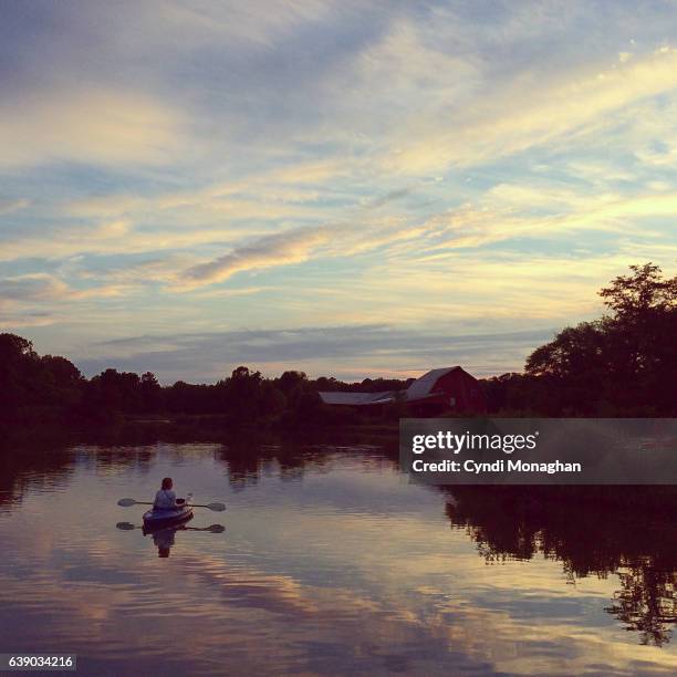 kayak beneath the sunset sky - wonderlust stock pictures, royalty-free photos & images