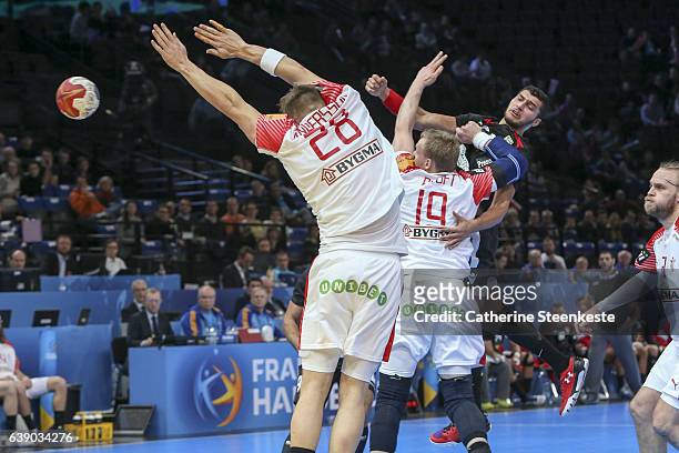 Yehia Elderaa of Egypt is trying to shoot the ball against Rene Toft Hansen and Lasse B Andersson of Denmark during the 25th IHF Men's World...