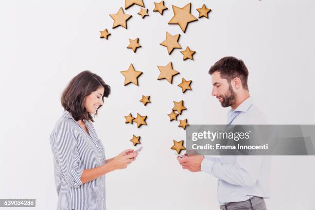 young man and woman texting stars - man blouse stock pictures, royalty-free photos & images