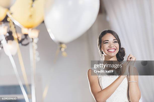 young mixed race woman in white dress at party - prom dress stockfoto's en -beelden