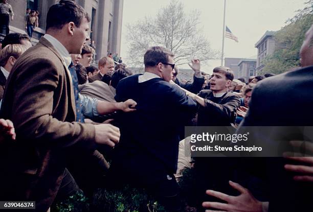 At Columbia University, a student protest turns physical as young men, one in a clerical collar, push one another, New York, New York, 1968. The...