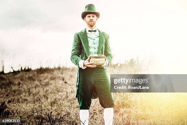 leprechaun man with pot of gold - leprechaun stock pictures, royalty-free photos & images