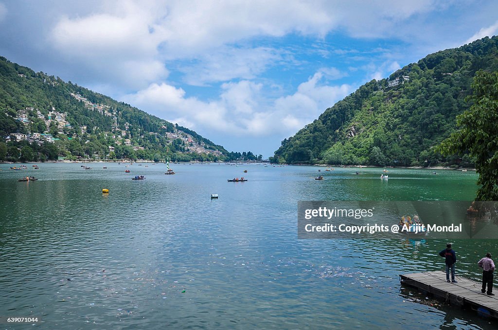 View Of Nainital Lake Surrounded By Mountains And Blue Sky