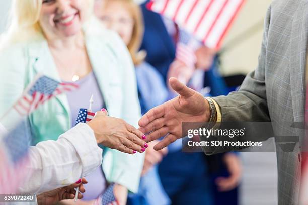 political candidate greets supporters during rally - local politics stockfoto's en -beelden