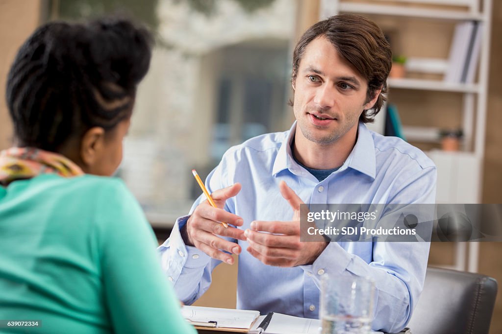 Mid adult businessman interviews potential employee