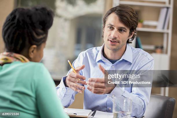 mid adult businessman interviews potential employee - business accuracy stock pictures, royalty-free photos & images