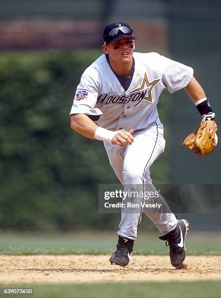 Craig Biggio of the Houston Astros fields during an MLB game versus the Chicago Cubs at Wrigley Field in Chicago, Illinois. Biggio played for the...